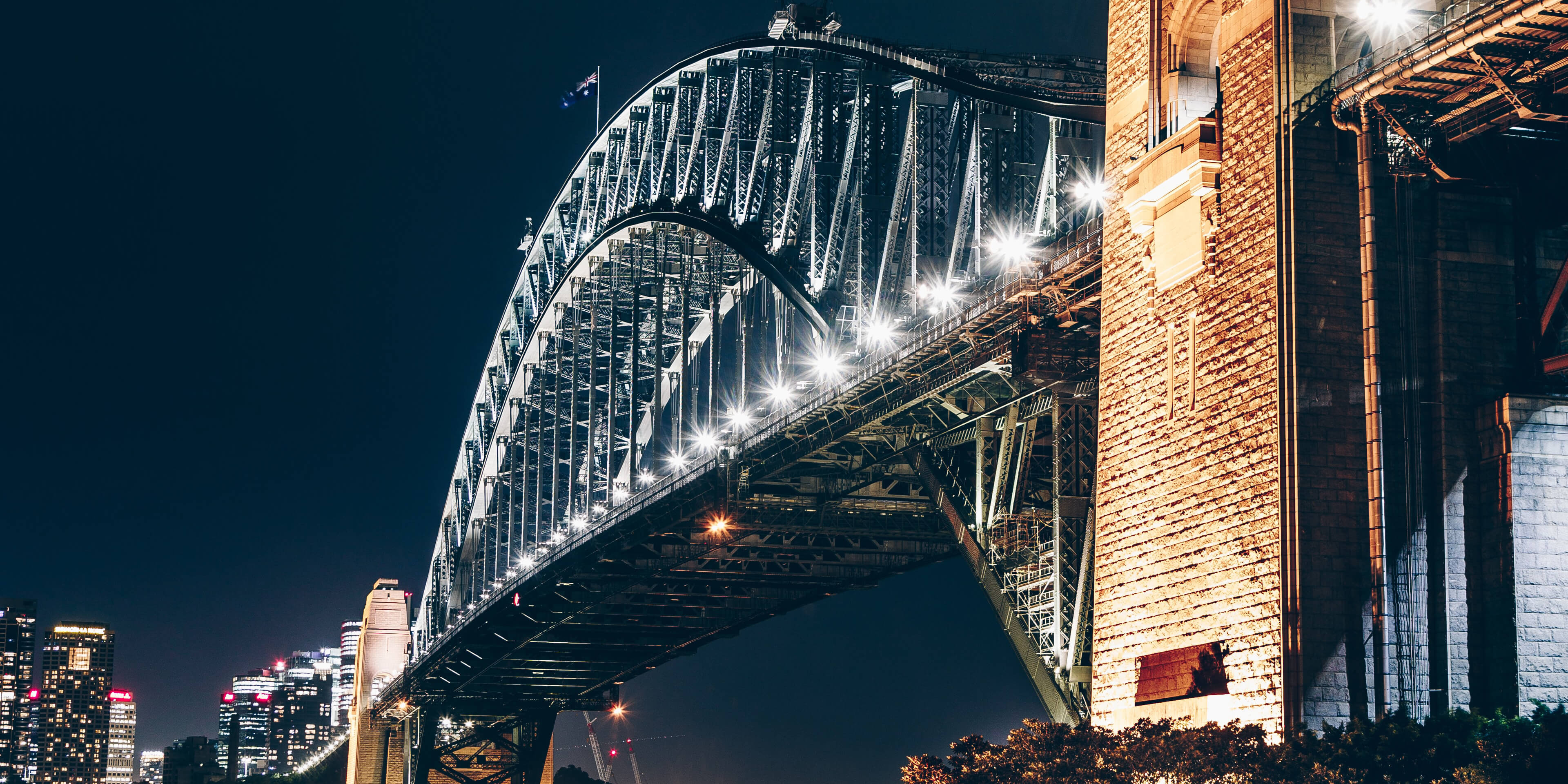 Close up of the Sydney Harbour bridge lit up at night