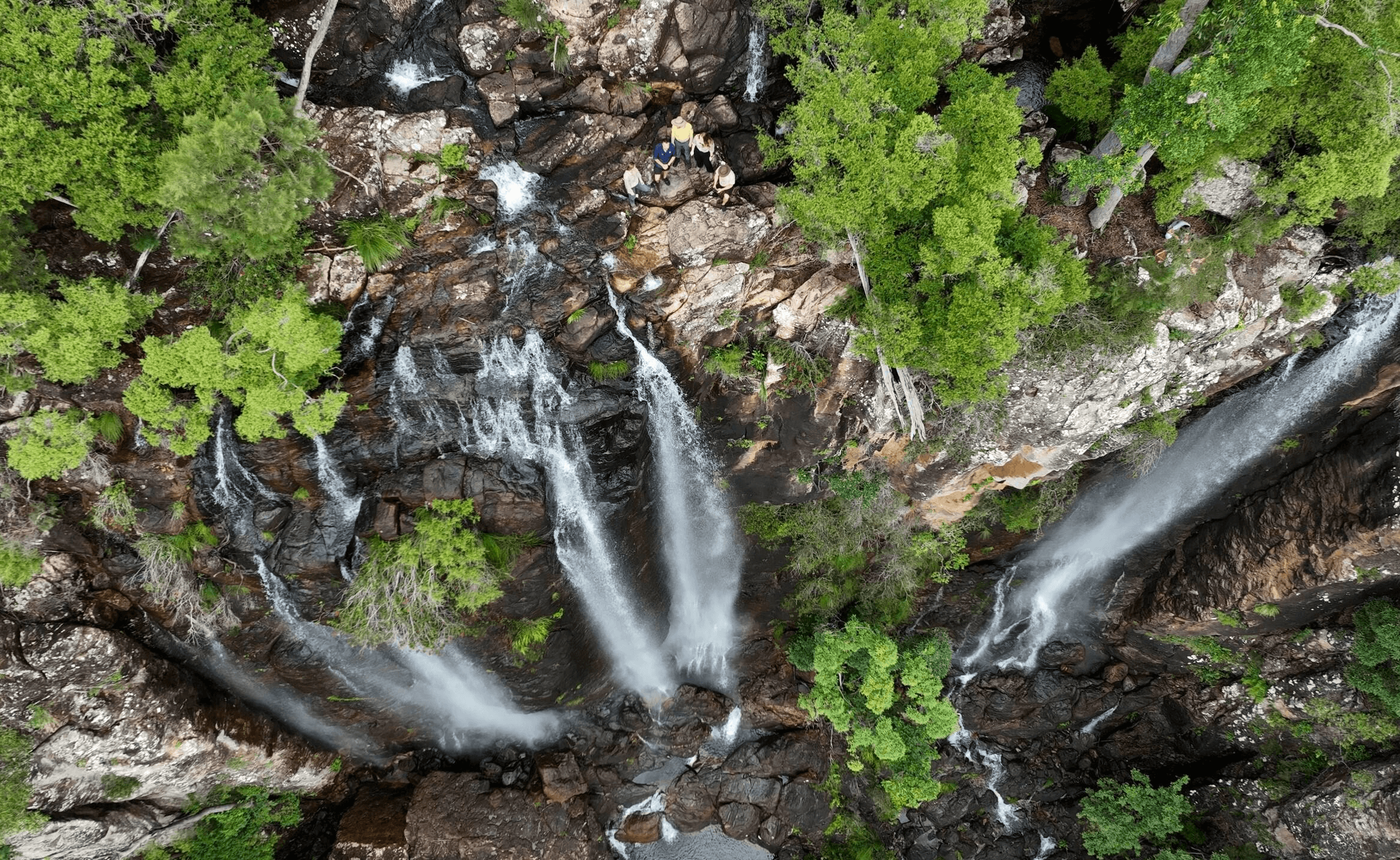 Image of a waterfall with people standing above it