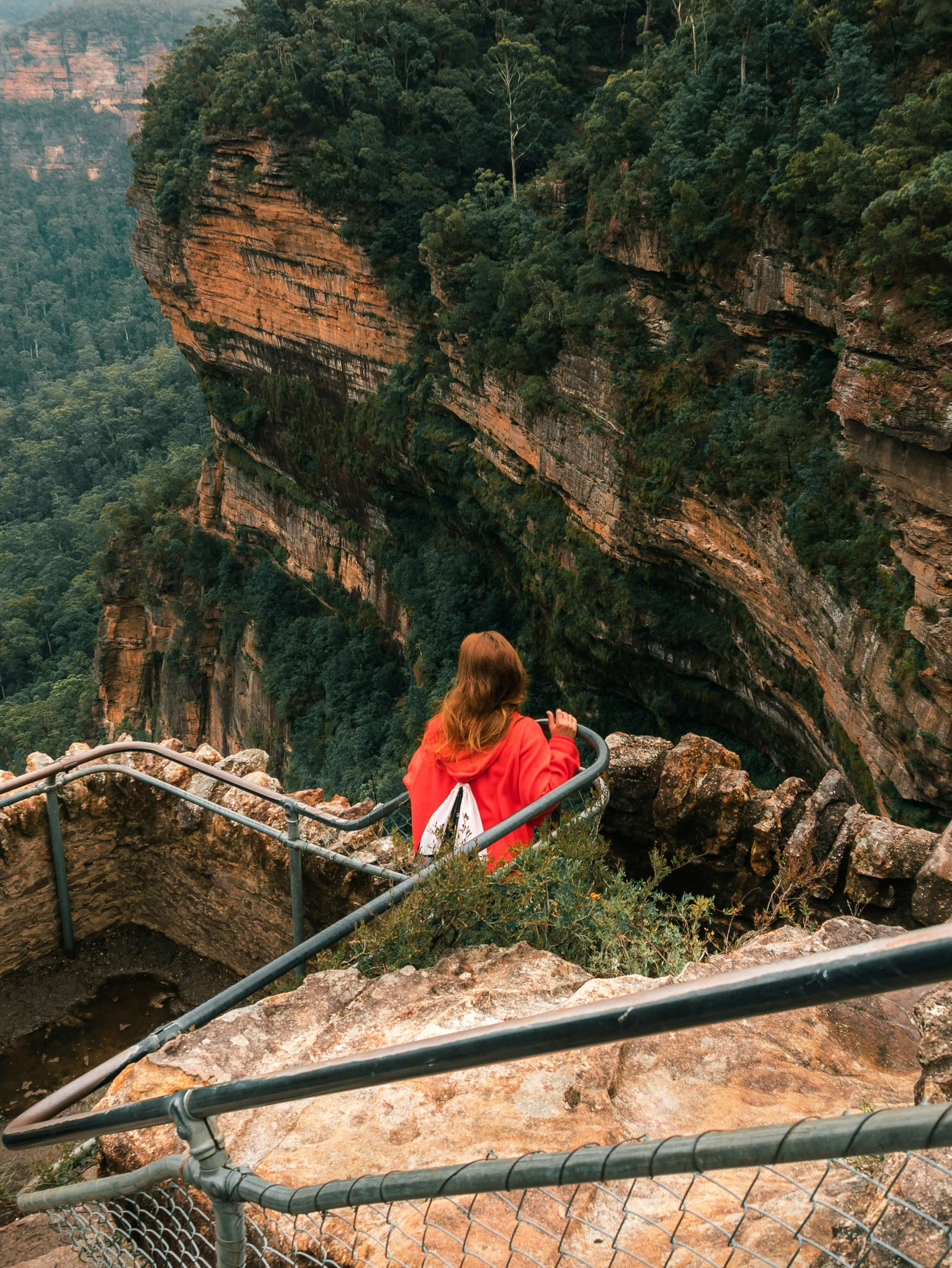 woman standing on a cliff face 